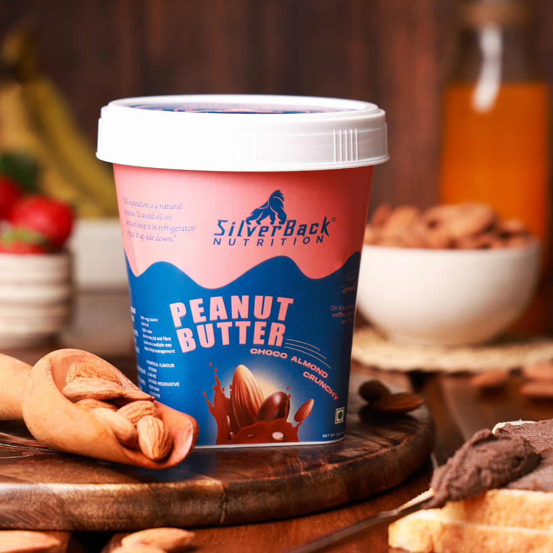 SilverBack Nutrition chocolate peanut butter jar with almonds, chocolate peanut cream in spoon, peanut butter spread on bread